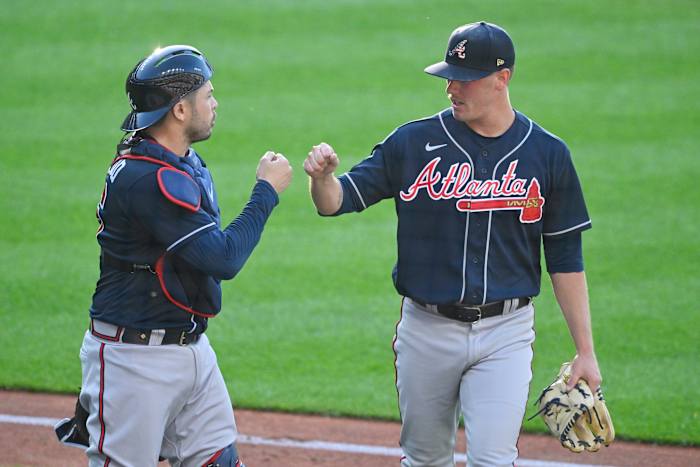 Jul 4, 2023; Cleveland, Ohio, USA; Atlanta Braves catcher Travis d'Arnaud (16) and starting pitcher Kolby Allard (49) celebrate in the second inning against the Cleveland Guardians at Progressive Field.